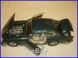 A Danbury mint of a scale model of a 1964 Aston Martin DB5 with clear box