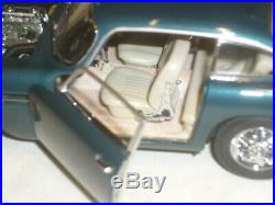 A Danbury mint of a scale model of a 1964 Aston Martin DB5 with clear box