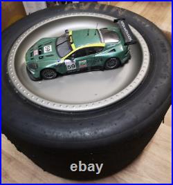 Aston Martin DBR9 118 scale model on actual used racing slick mancave display